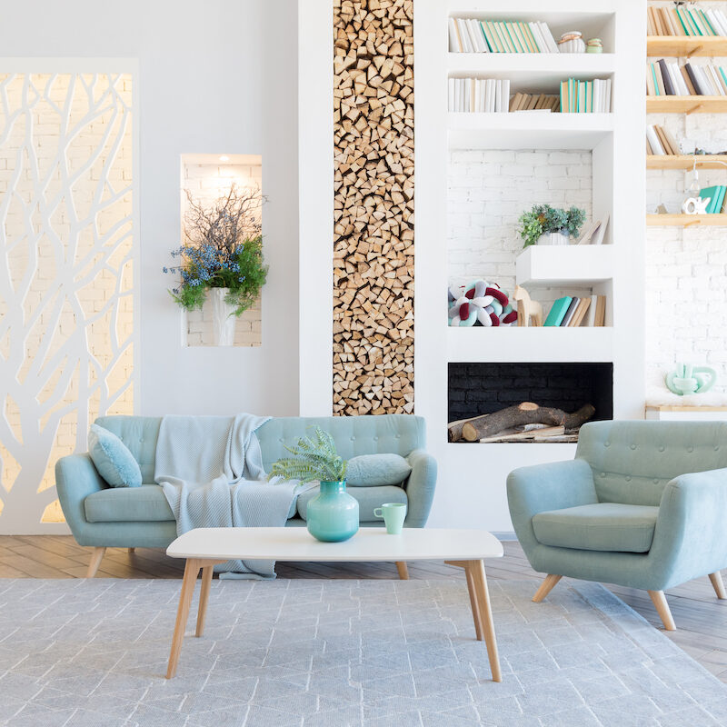 Bright modern living room with pastel furniture and wood accents.