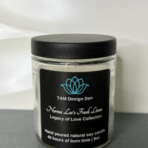 A jar of natural cream labeled 'Love Never Fails' by TAM Design Den.
